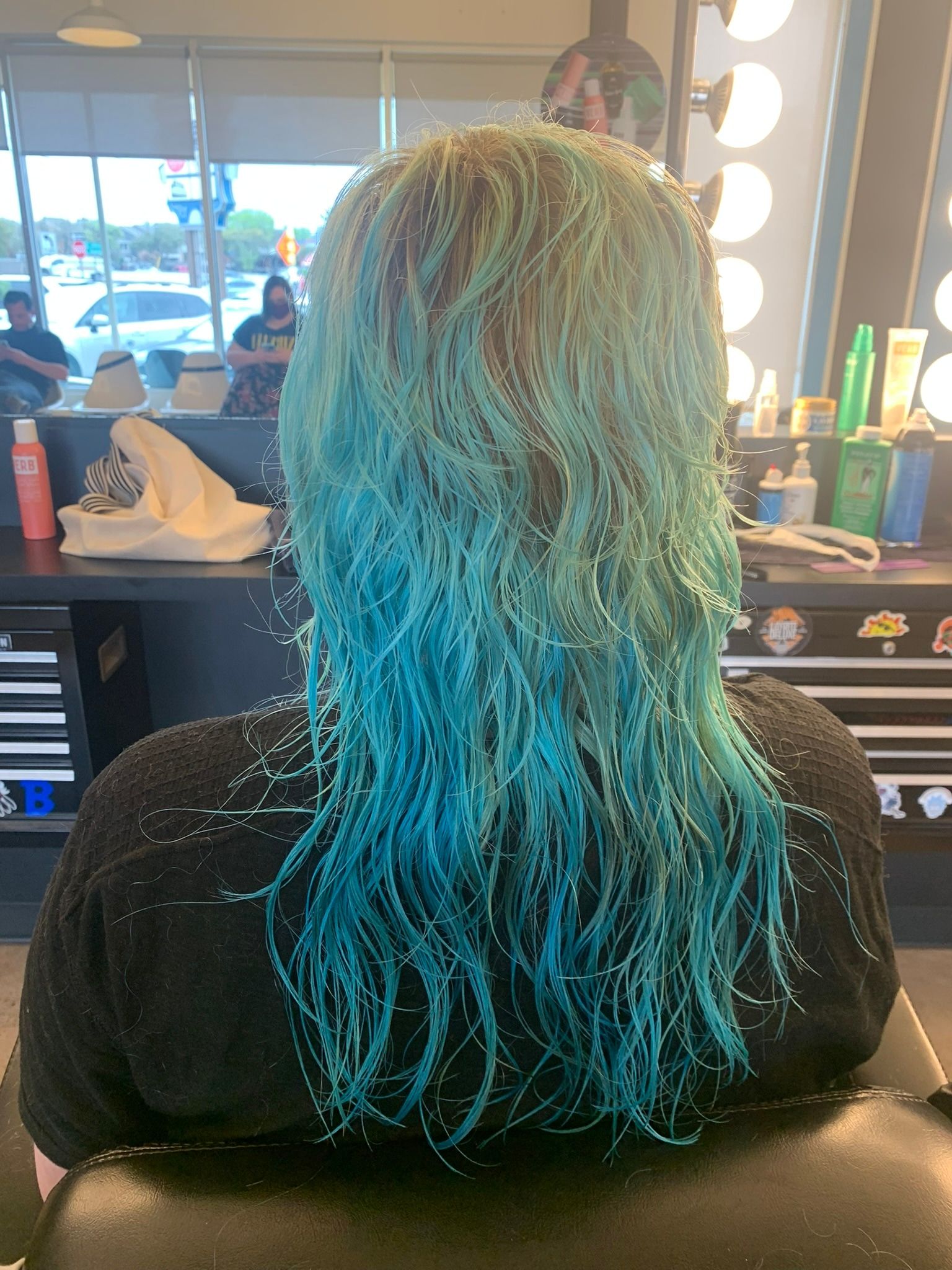 Aqua-to-blue color blend through a textured shoulder-length cut