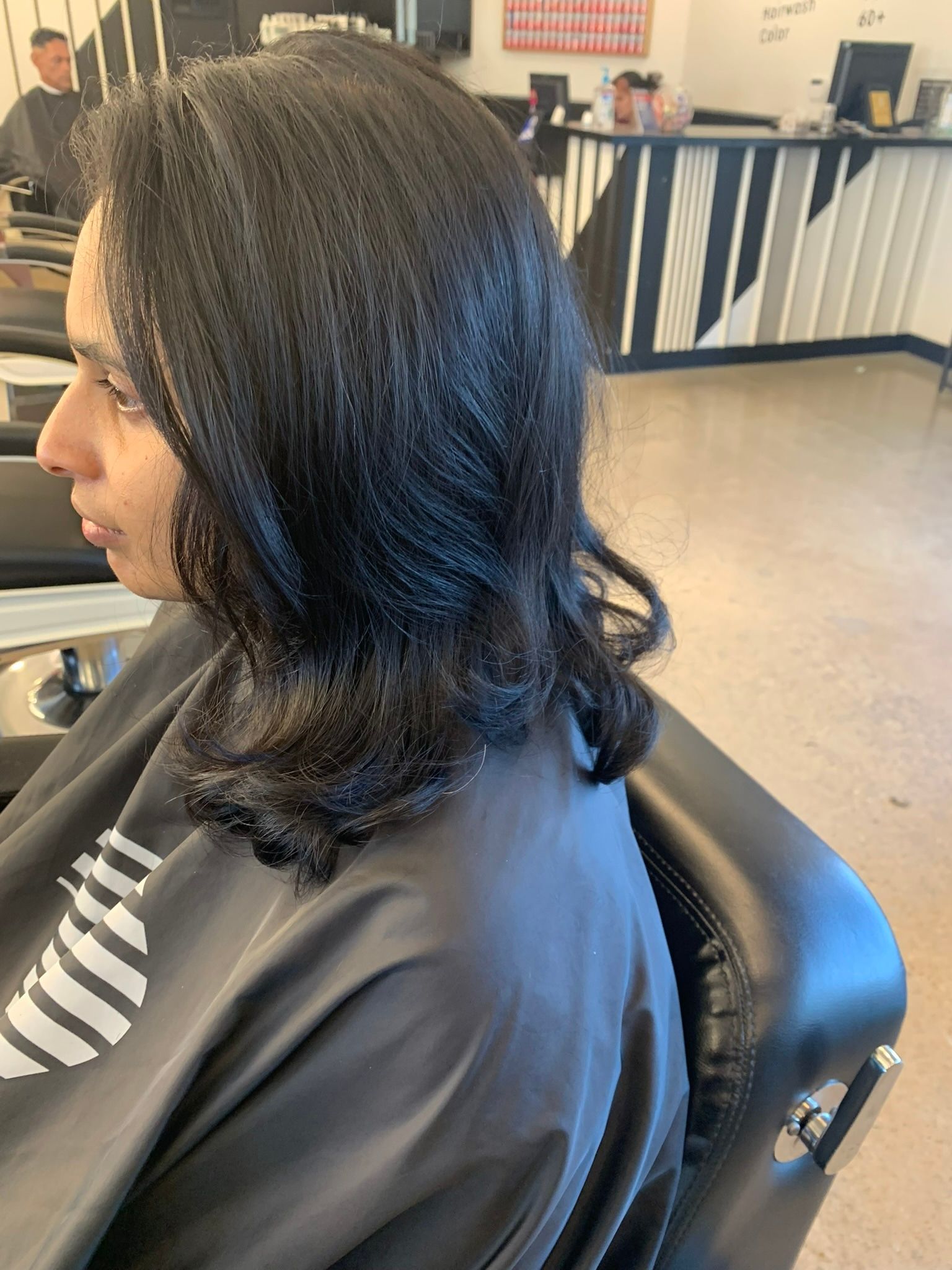 Glossy black shoulder-length layers with curled ends