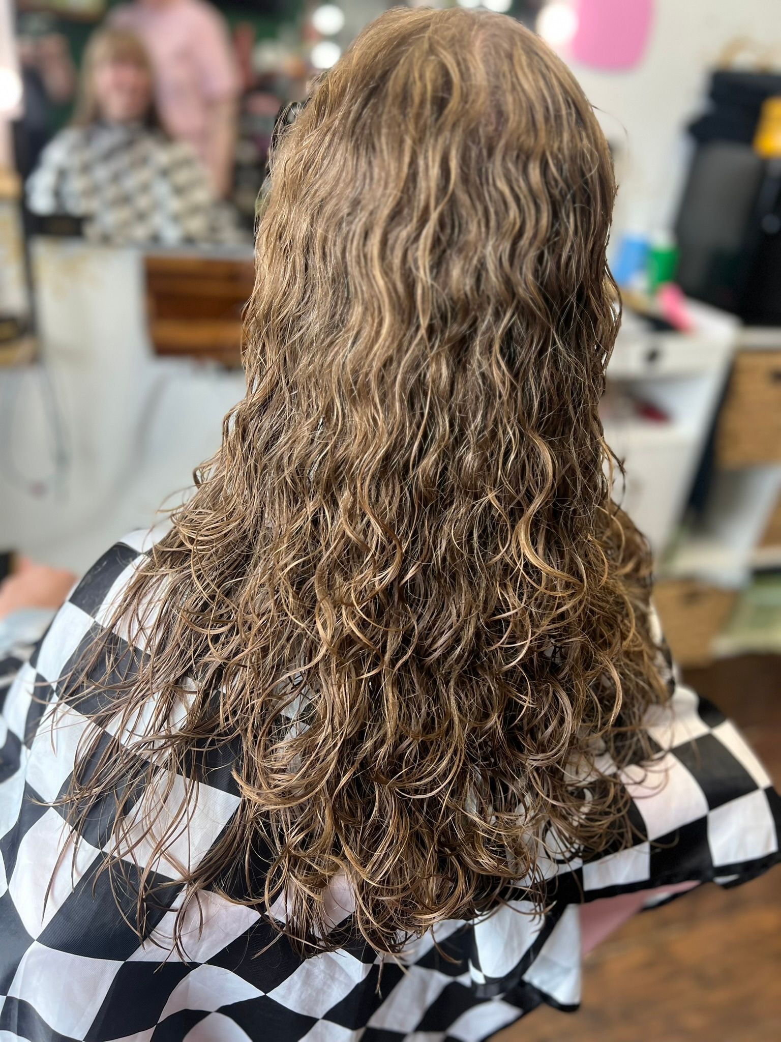 Long blonde hair styled in soft, defined waves